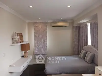 Cozy bedroom with modern decor and soft lighting, featuring a comfortable bed and stylish shelves.