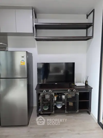 Modern kitchen with stainless steel fridge and industrial-style shelving