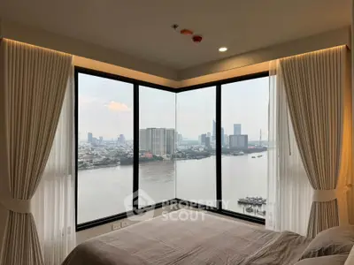 Stunning corner bedroom with panoramic river view and floor-to-ceiling windows.