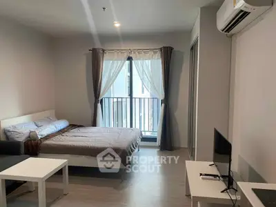 Modern studio apartment with cozy bedroom and balcony view