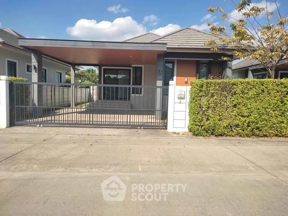 Charming single-story house with modern design and lush greenery in a serene neighborhood.