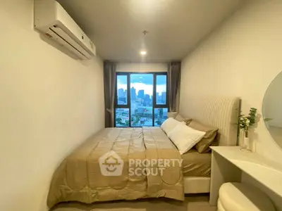 Cozy bedroom with city view, featuring a comfortable bed and modern decor.