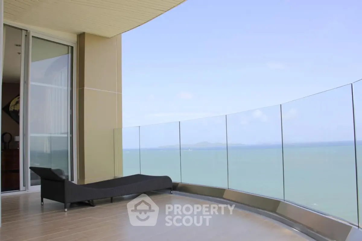 Luxurious balcony with stunning ocean view and modern glass railing
