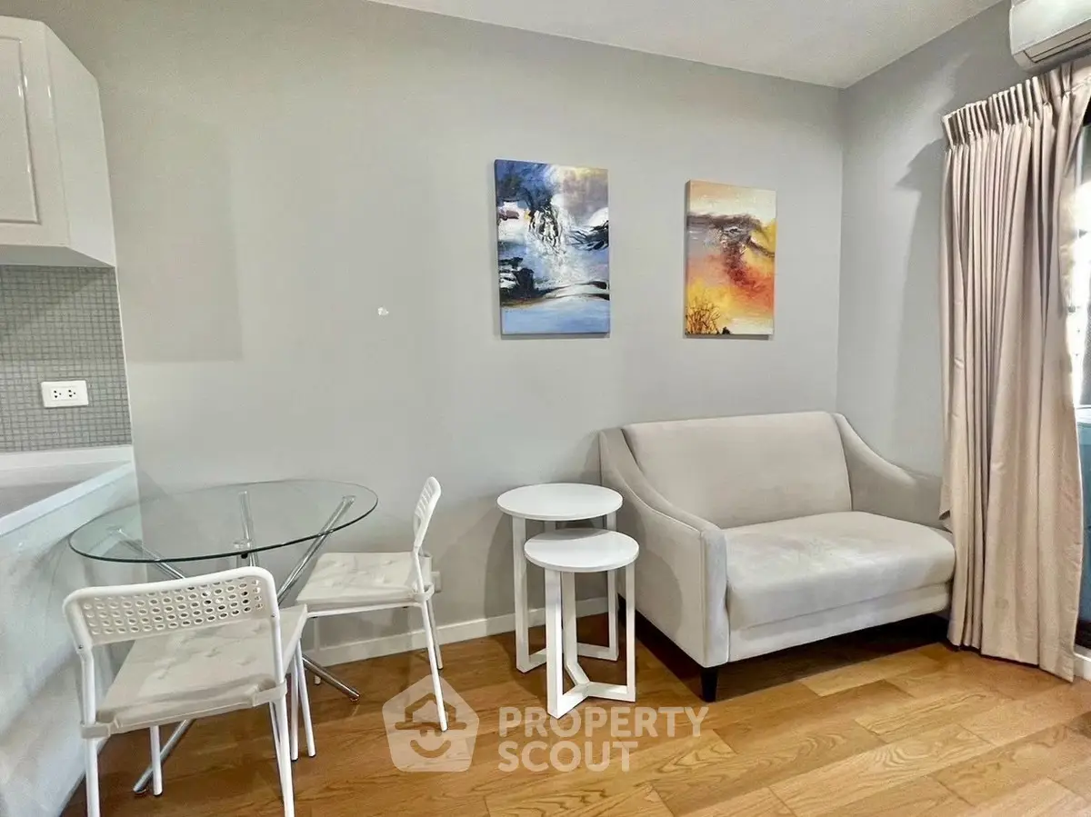 Modern living room with cozy sofa, stylish decor, and elegant dining area in a bright apartment.