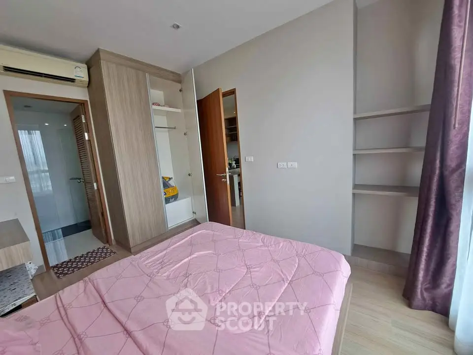 Modern bedroom with built-in wardrobe and large window for natural light