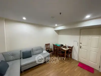 Cozy living room with modern furniture and dining area, perfect for relaxation and entertaining guests.