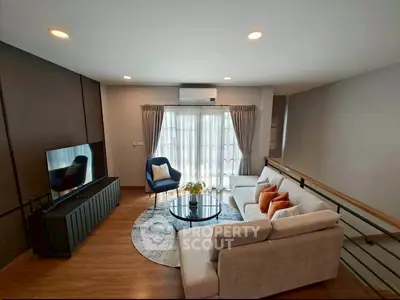 Modern living room with stylish furniture and natural light, featuring a cozy sofa and elegant decor.