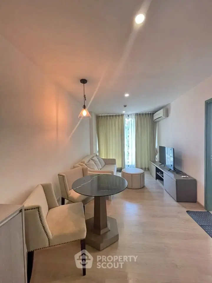 Modern living room with cozy seating and natural light, perfect for relaxation and entertainment.