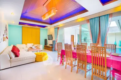 Spacious living room with vibrant decor and modern dining area, perfect for entertaining guests.