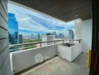 Spacious balcony with stunning city skyline view in modern high-rise building.