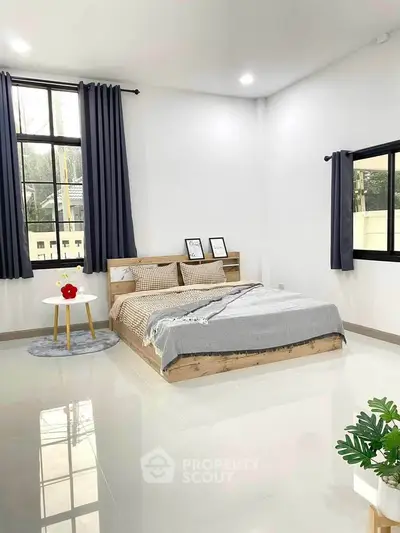 Spacious modern bedroom with large windows and stylish decor