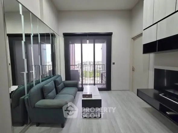 Modern living room with sleek design and balcony view in a stylish apartment.