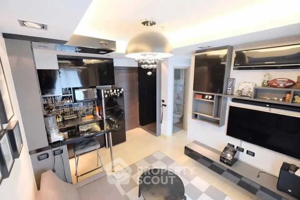 Modern living room with open kitchen, sleek design, and stylish decor in a contemporary apartment.