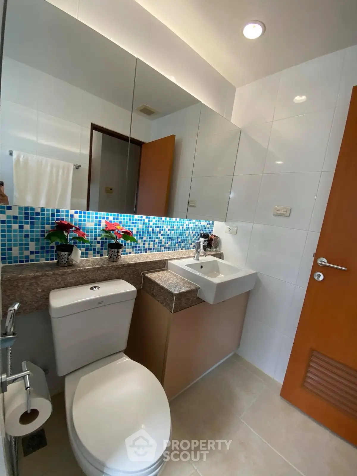 Modern bathroom with stylish mosaic tiles and sleek fixtures in a contemporary apartment.