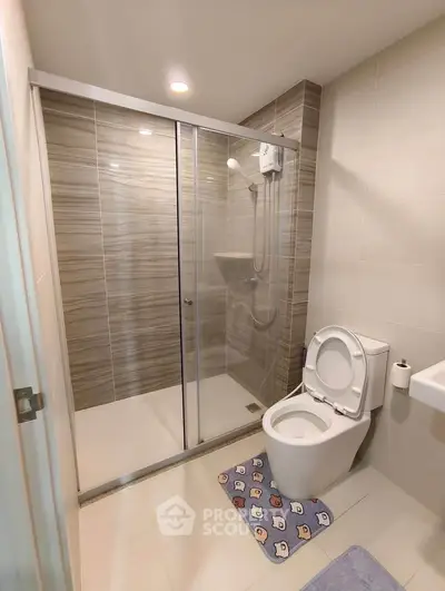 Modern bathroom with glass shower and sleek tile design