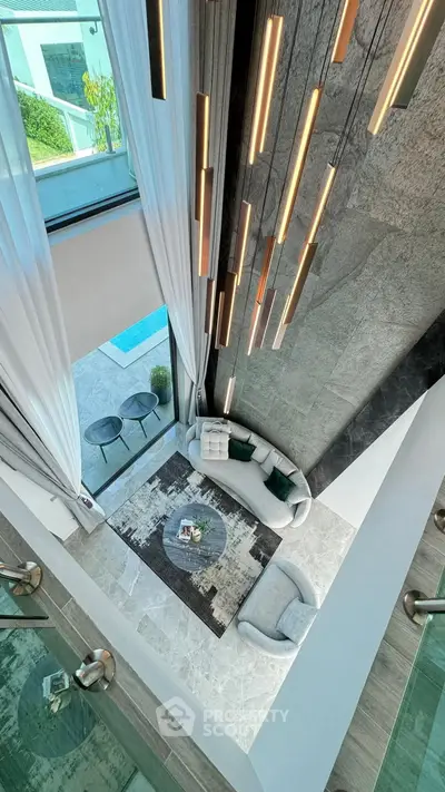 Luxurious modern living room with high ceiling and elegant lighting