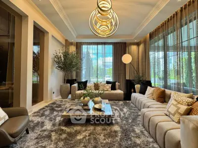Luxurious living room with modern decor and large windows offering a serene garden view.