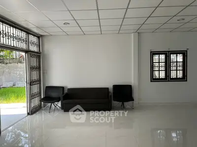Spacious living room with modern furniture and large windows for natural light.