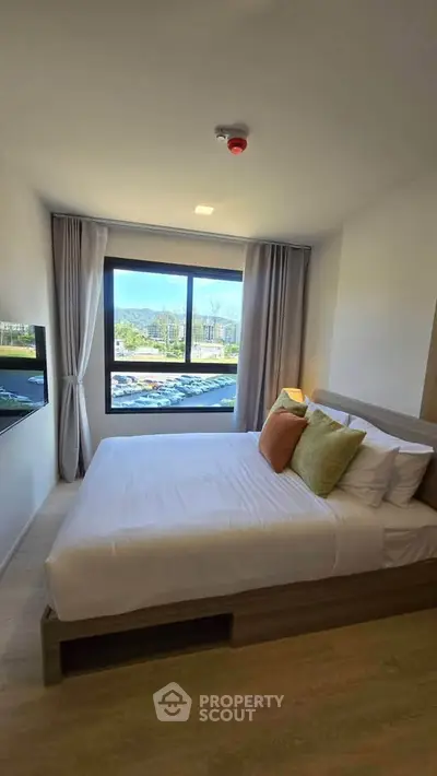 Cozy bedroom with scenic window view and modern decor