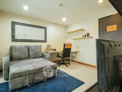 Modern study room with cozy sofa and sleek desk setup, perfect for productivity and relaxation.