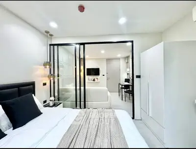 Modern bedroom with sleek design and glass partition in stylish apartment