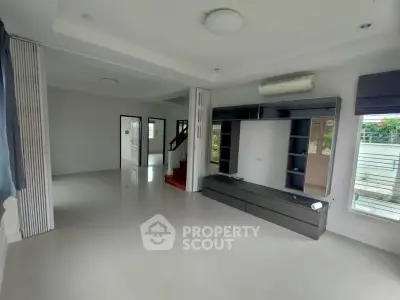 Spacious modern living room with sleek built-in storage and large windows