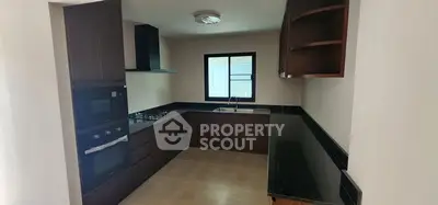 Modern kitchen with sleek cabinetry and built-in appliances in a cozy layout.