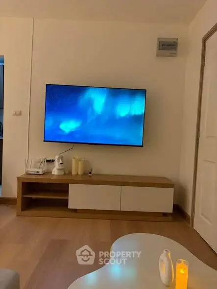 Cozy living room with modern TV setup and ambient lighting