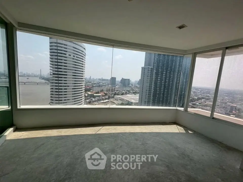 Spacious corner unit with panoramic city and river views, featuring floor-to-ceiling windows.