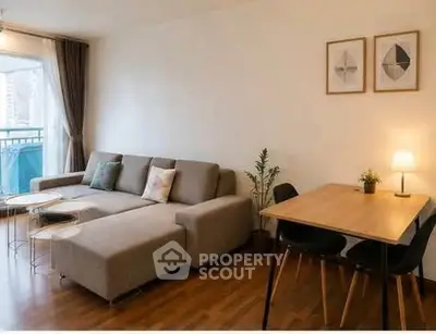 Modern living room with stylish furniture and natural light in urban apartment.