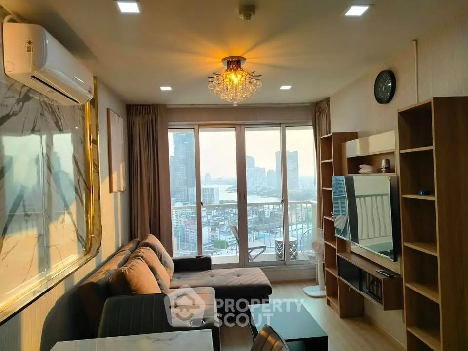 Modern living room with city view, stylish furniture, and elegant lighting in a high-rise apartment.
