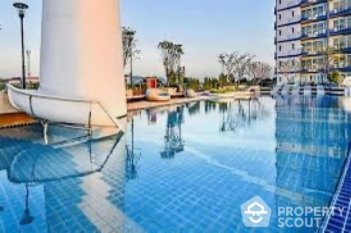 Luxurious apartment complex with stunning outdoor pool and modern architecture.