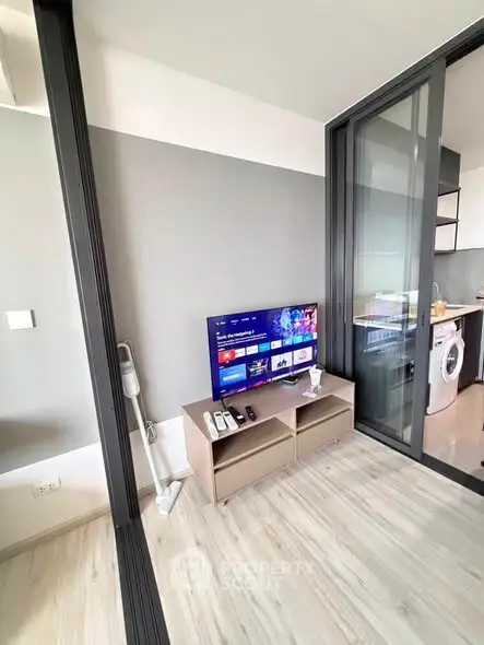 Modern living room with sliding glass doors and sleek kitchen appliances