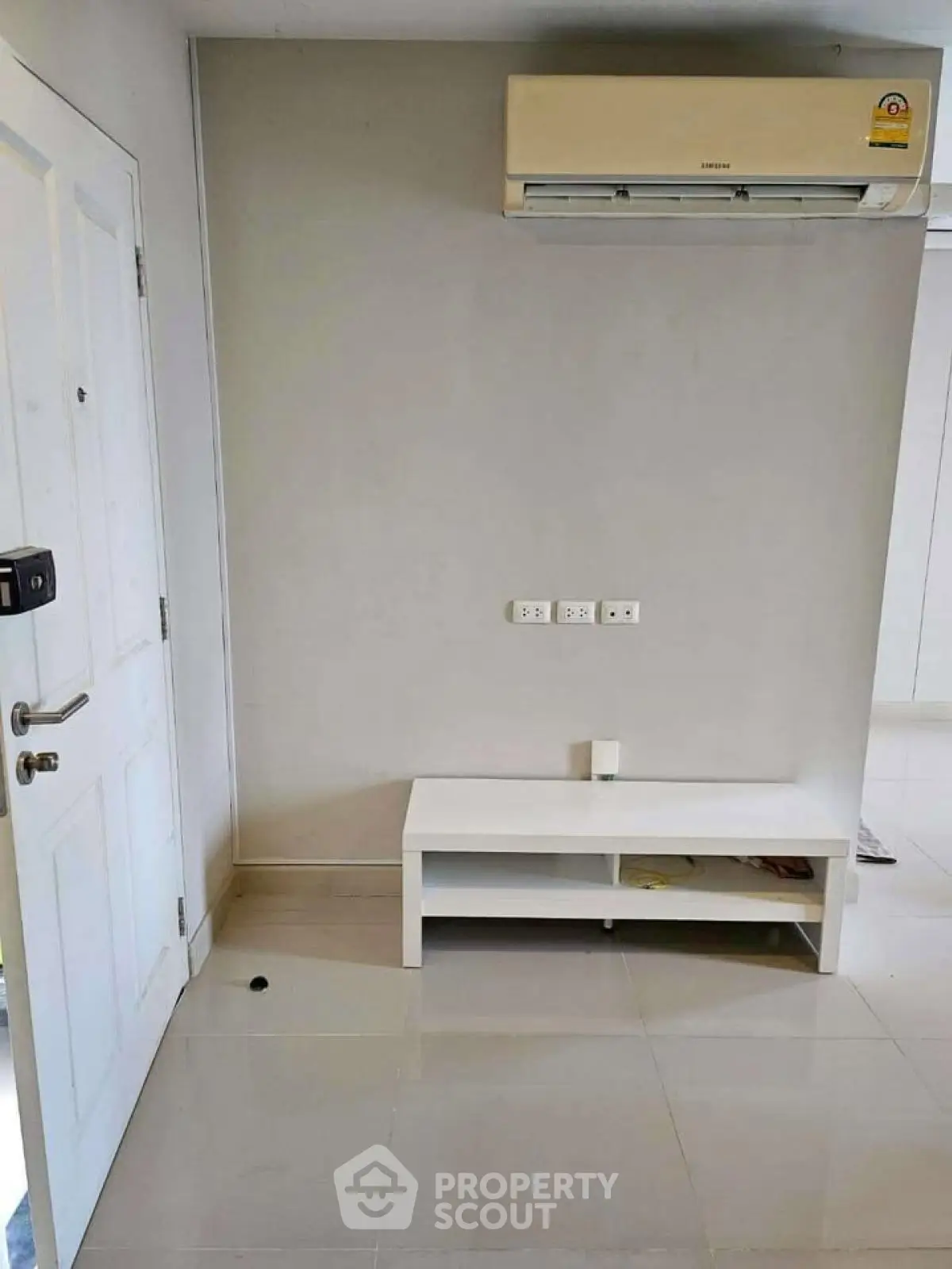 Minimalist interior with air conditioning and white furniture in modern apartment.