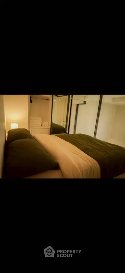 Cozy bedroom with warm lighting and mirrored wardrobe