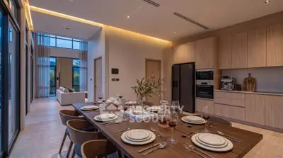 Luxurious open-plan kitchen and dining area with modern appliances and elegant decor.