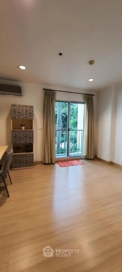 Spacious living room with balcony access and modern decor