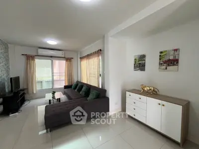 Spacious living room with modern decor and large windows for natural light.