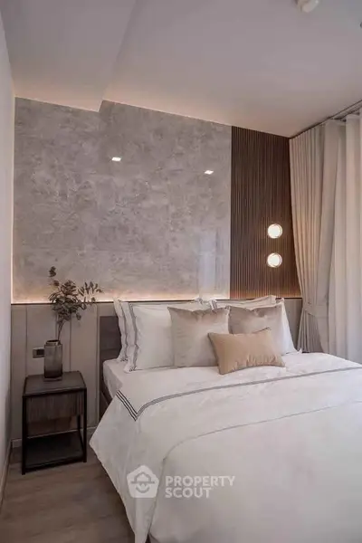 Elegant bedroom with modern decor and soft lighting, featuring a cozy bed and stylish wall accents.