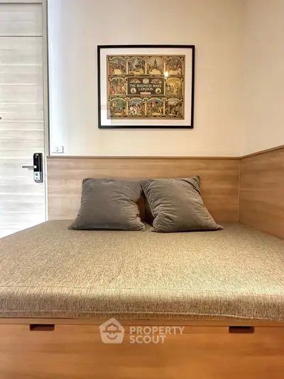 Cozy bedroom with wooden accents and framed artwork above bed