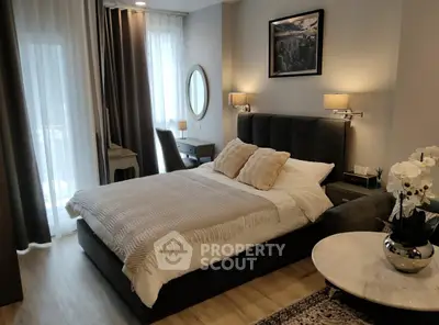 Luxurious bedroom with elegant decor and natural light, featuring a plush bed and stylish furnishings.