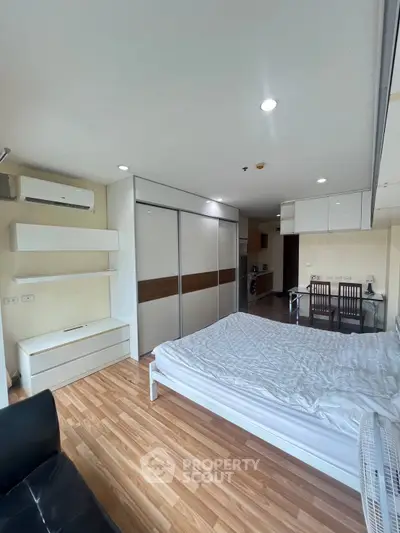Modern studio apartment with wooden flooring and sleek furnishings