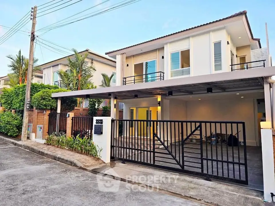 Modern two-story house with spacious driveway and sleek design in a suburban neighborhood.