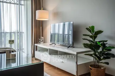 Modern living room with sleek TV stand, large window, and stylish decor