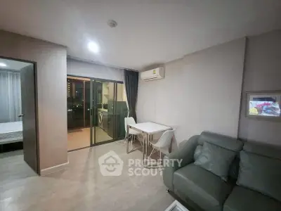 Modern living room with balcony access and air conditioning in a stylish apartment.