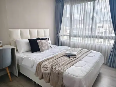 Modern bedroom with cozy bed and city view through large window
