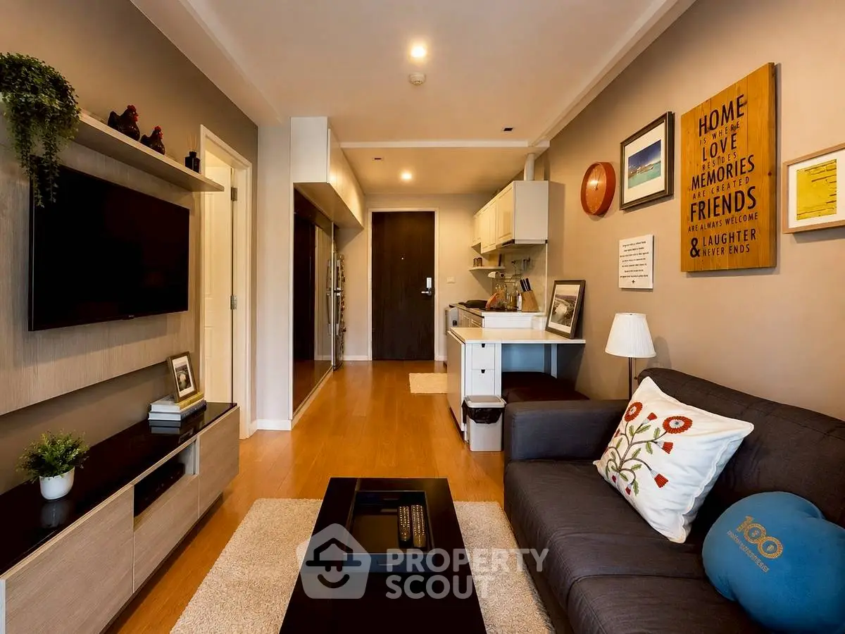 Modern living room with stylish decor and open layout, featuring a cozy sofa and wall-mounted TV.