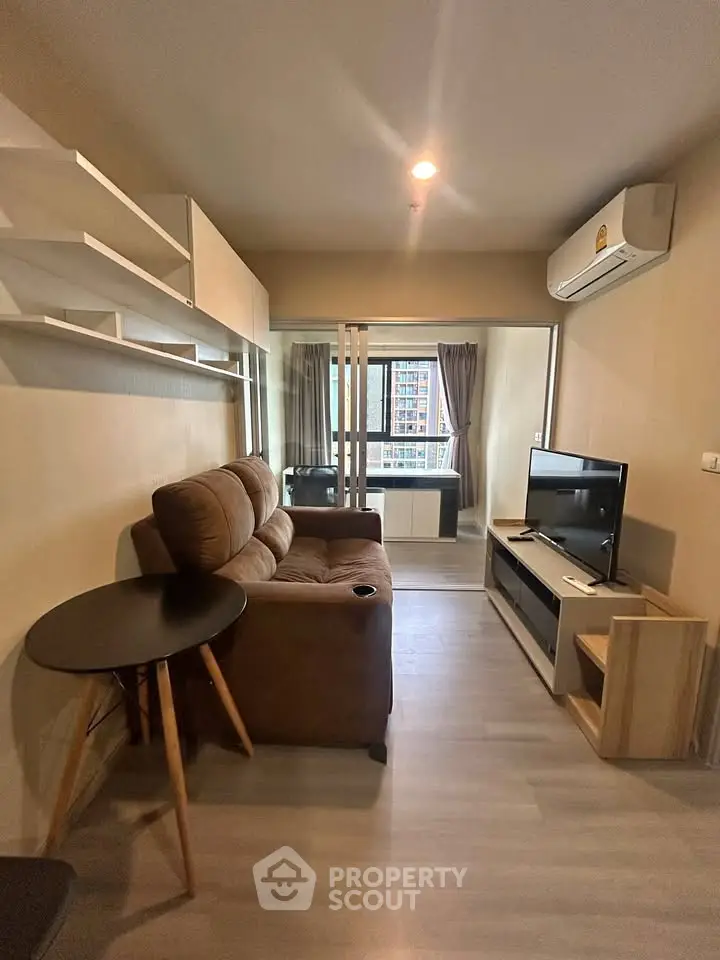 Modern living room with cozy sofa, TV, and air conditioning in a stylish apartment.