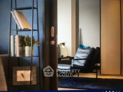 Stylish modern living room with sleek black chair and bookshelf, perfect for urban living.