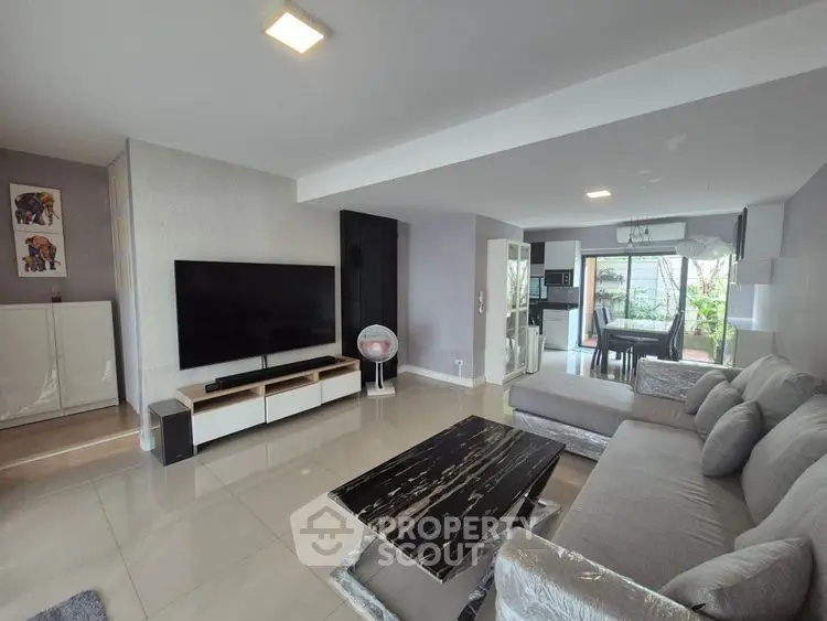 Spacious modern living room with sleek furniture and open layout, perfect for entertaining.